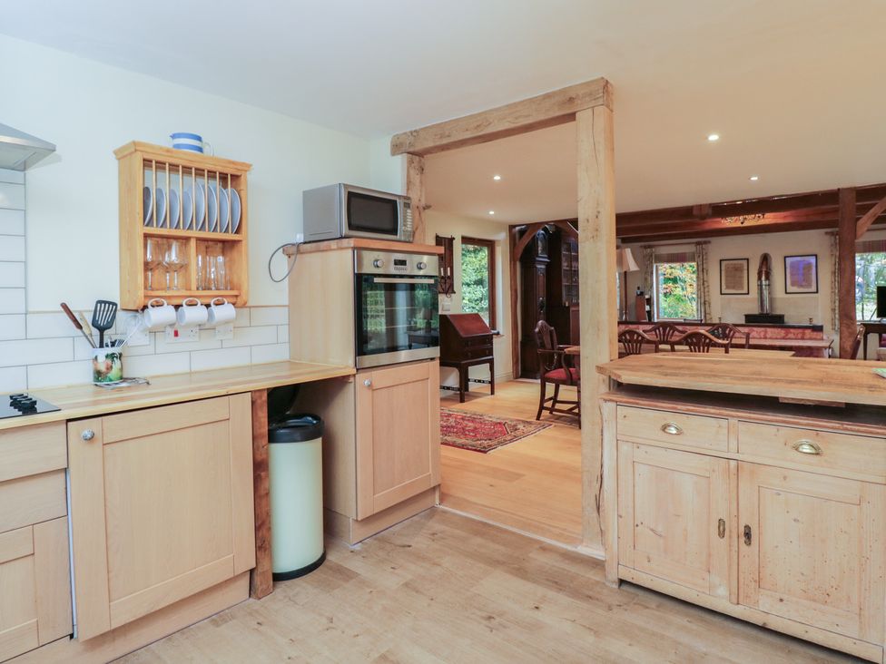 A kitchen with cabinets and appliances at Gardeners Hill Annex