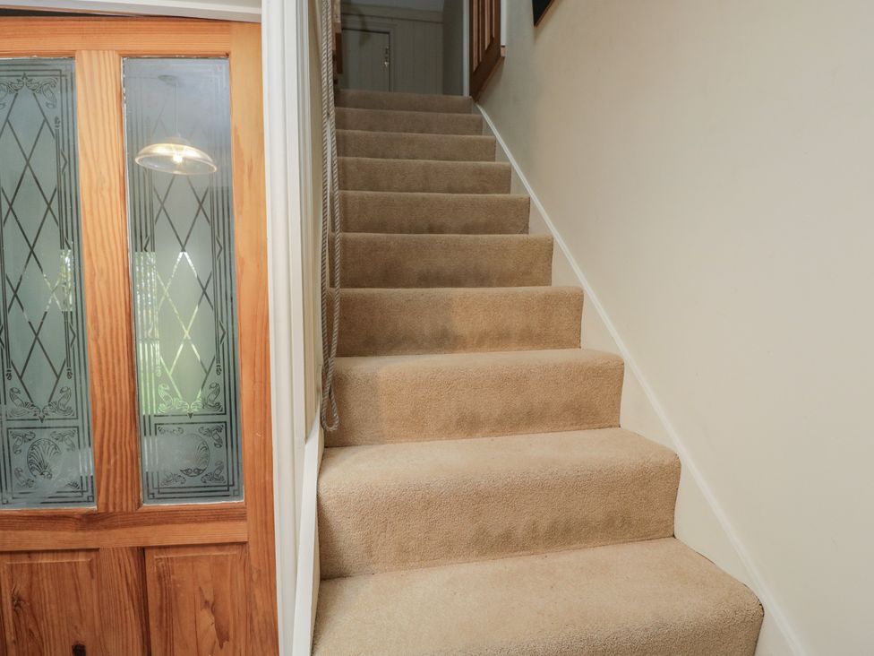 A staircase and door in a hallway at Gardeners Hill Annex