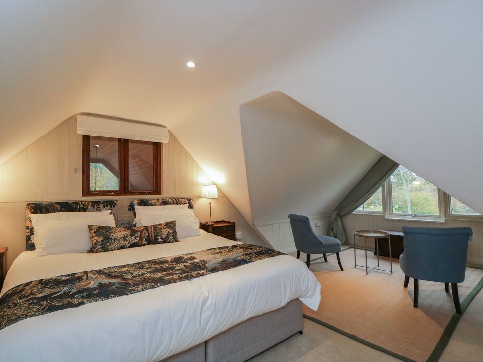 A bedroom with a bed and seating area at Gardeners Hill Annex