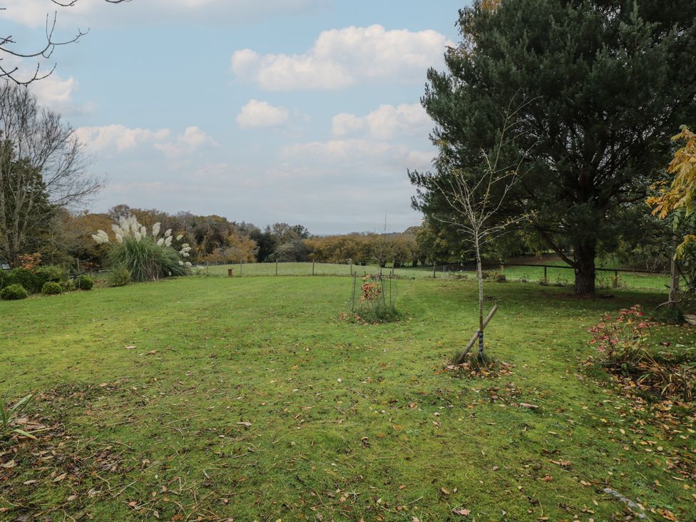 An outdoor area with grass and trees at Gardeners Hill Annex