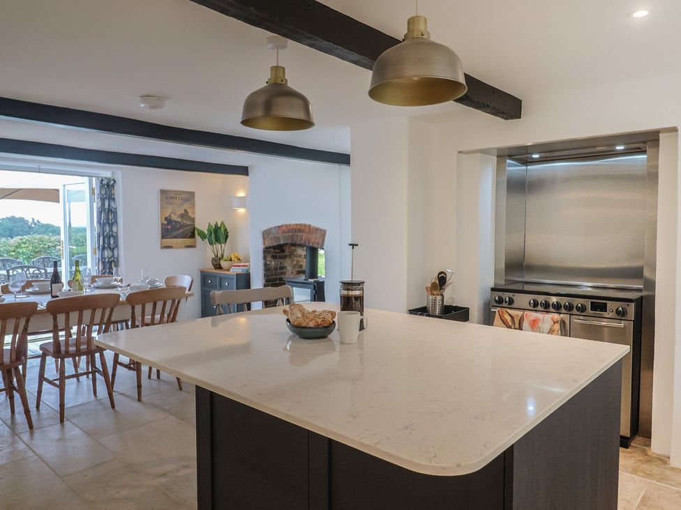 A kitchen with a dining table and chairs at The Old Inn in Winterborne Whitechurch