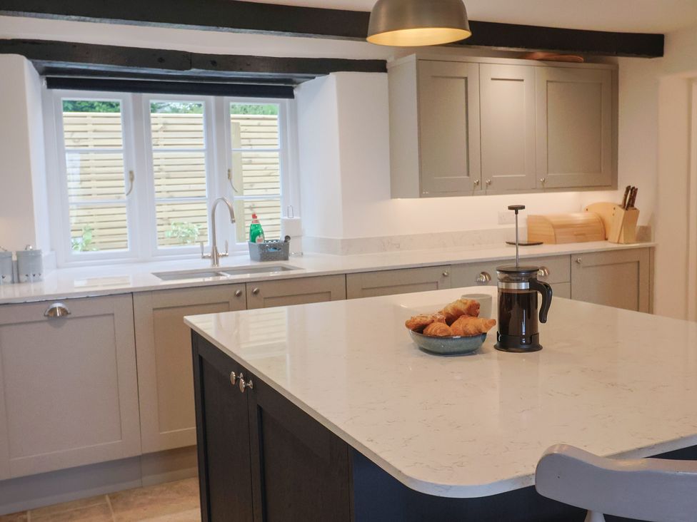A kitchen with cabinets and a sink at The Old Inn in Winterborne Whitechurch