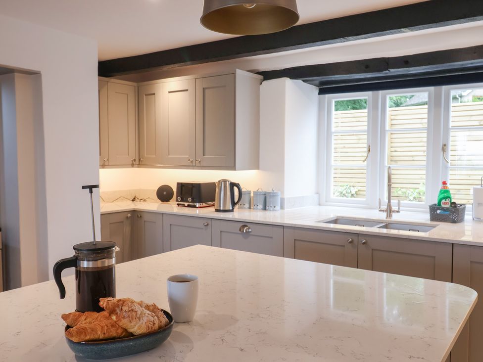 A kitchen with a coffee maker and croissants on the countertop at The Old Inn in Winterborne Whitechurch