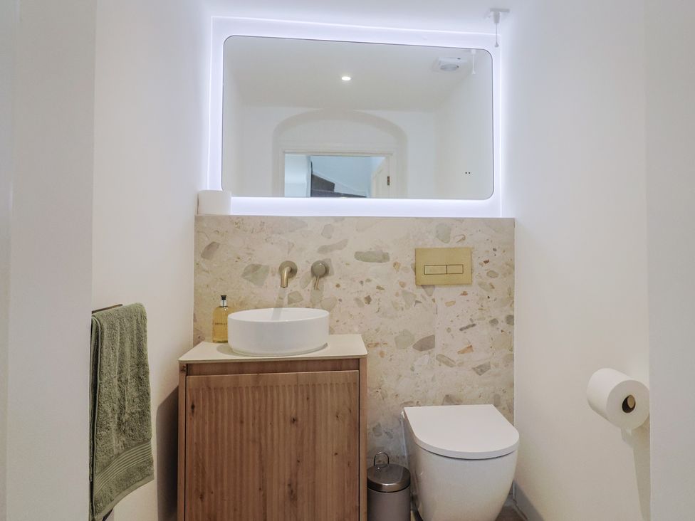 A bathroom with a sink and toilet at The Old Inn in Winterborne Whitechurch