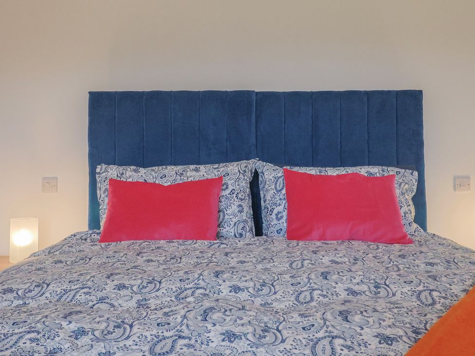 A bedroom with a bed and pillows at The Old Inn in Winterborne Whitechurch