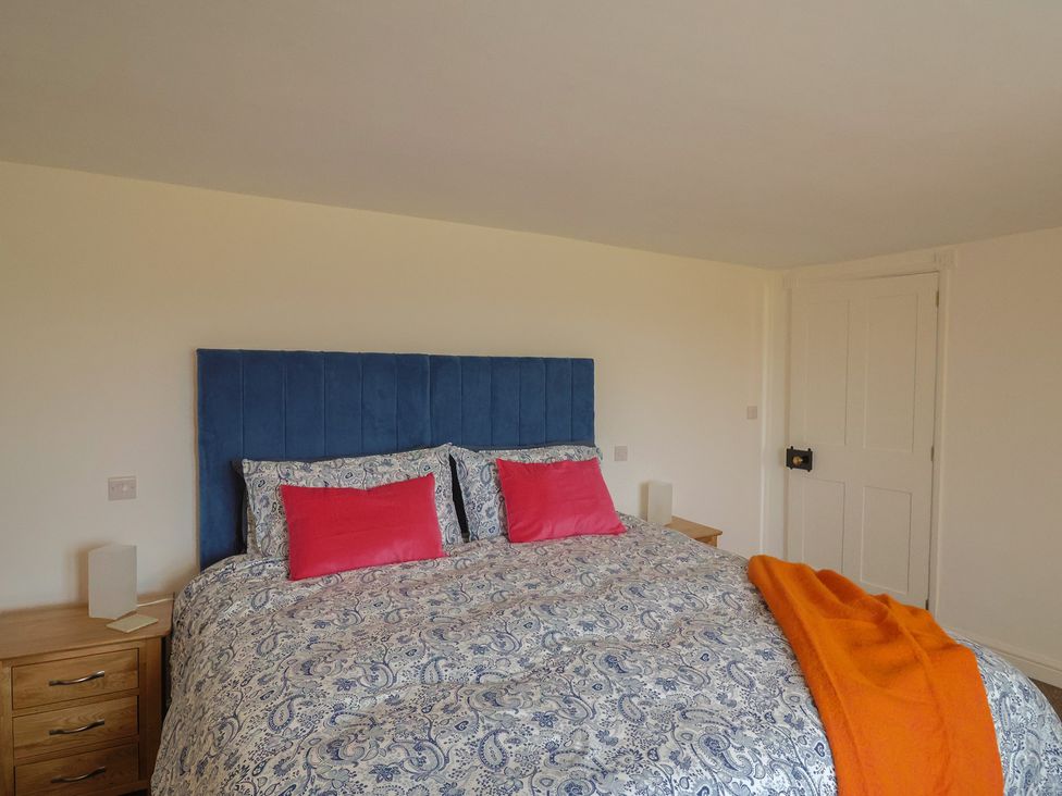 A bedroom with a bed and bedside tables at The Old Inn in Winterborne Whitechurch