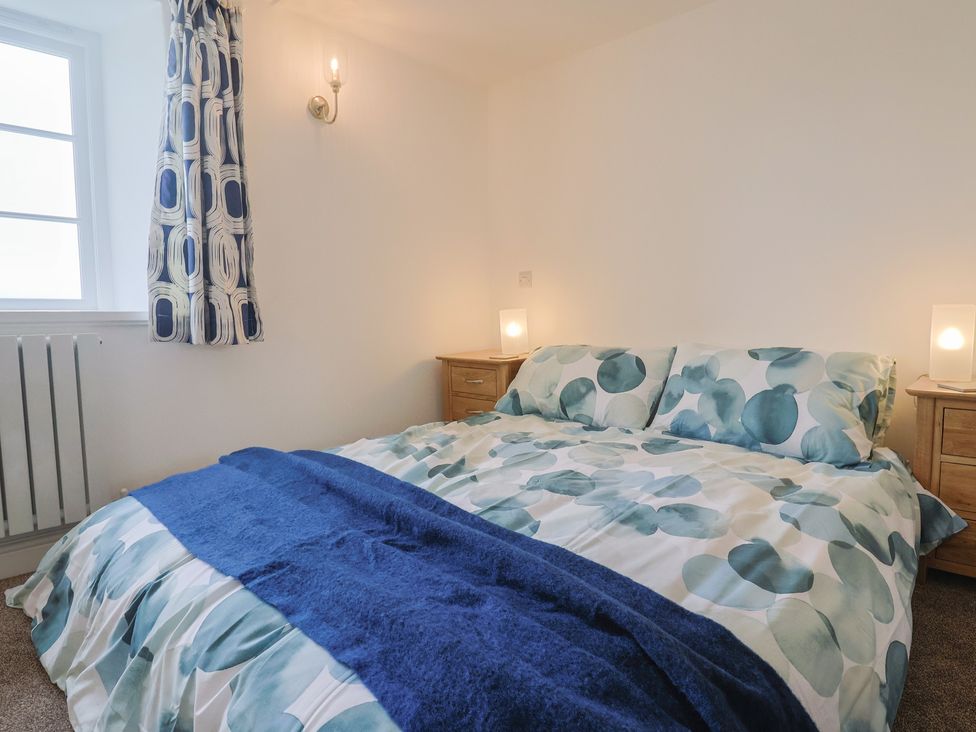 A bedroom with a bed and nightstands at The Old Inn Winterborne Whitechurch