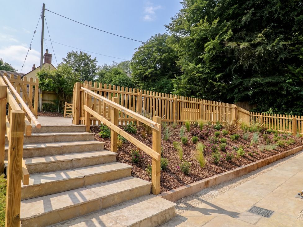 A garden with stairs and a wooden fence at The Old Inn in Winterborne Whitechurch