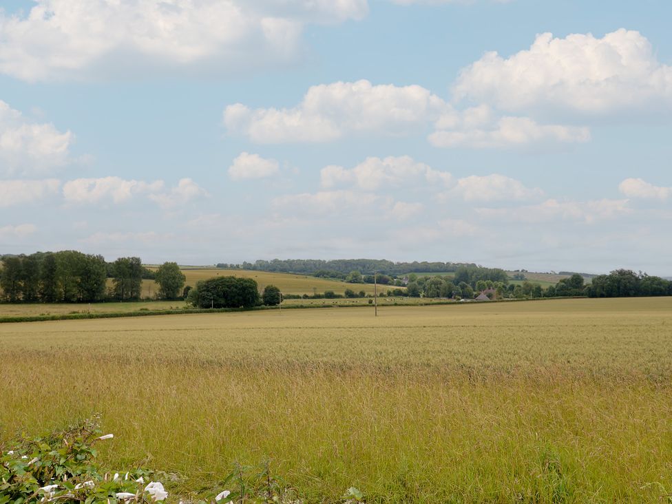 A landscape of fields and hills under a cloudy sky at The Old Inn Winterborne Whitechurch