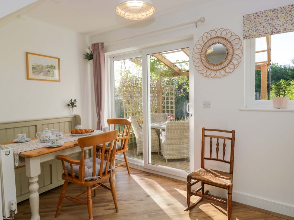 A dining room with a table and chairs at 27 Oversands View