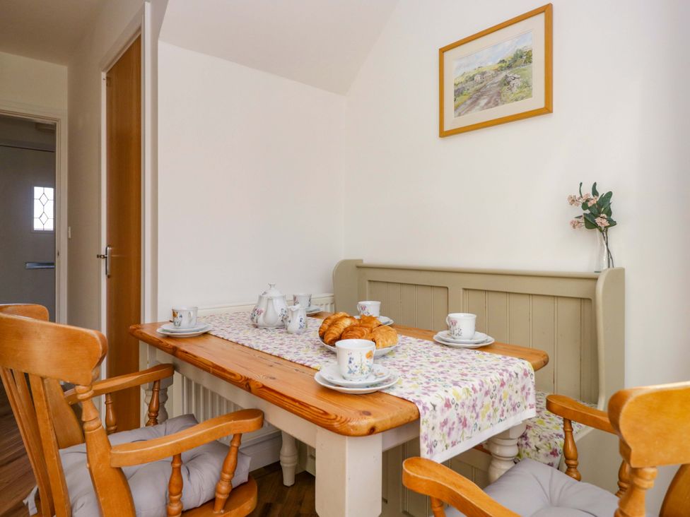 A dining room with a table set for tea at 27 Oversands View