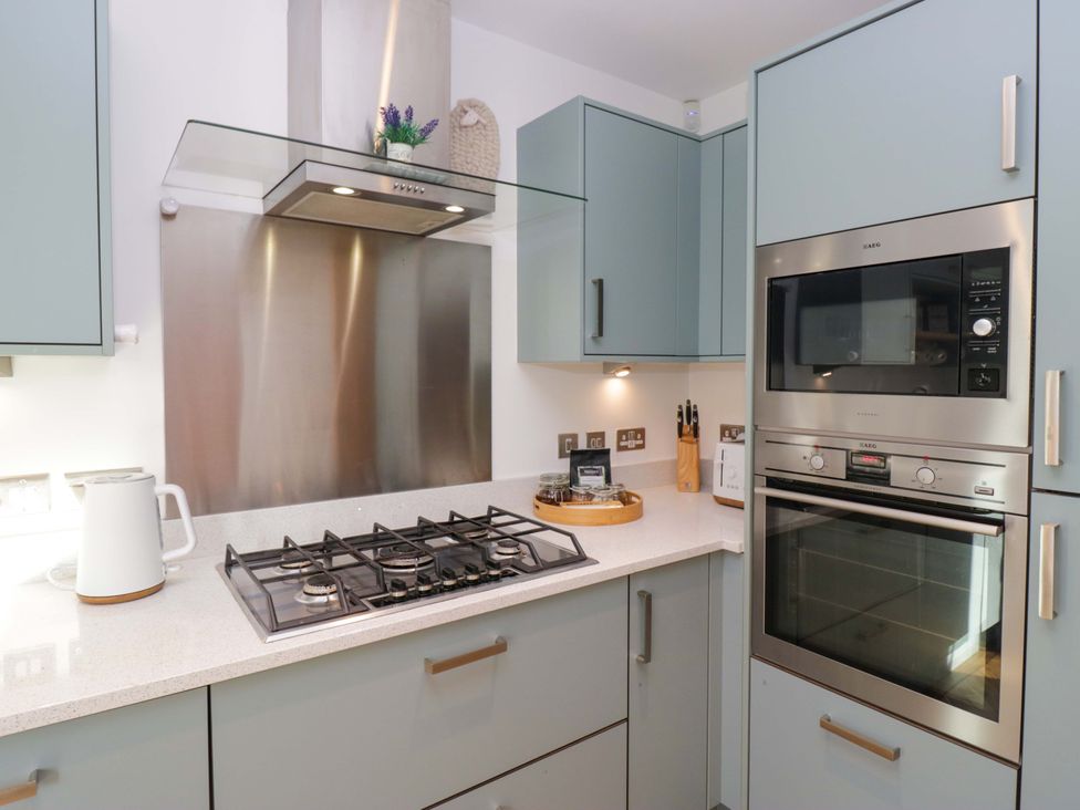 A kitchen with a gas stove and built-in oven at 27 Oversands View