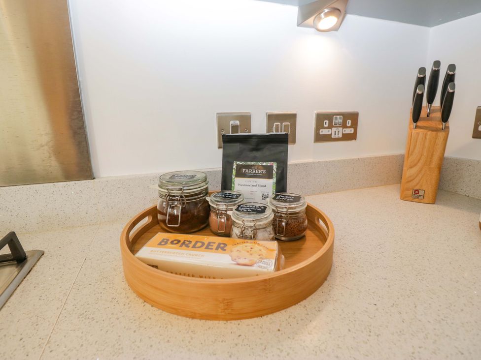 A kitchen counter with jars and a bamboo tray at 27 Oversands View