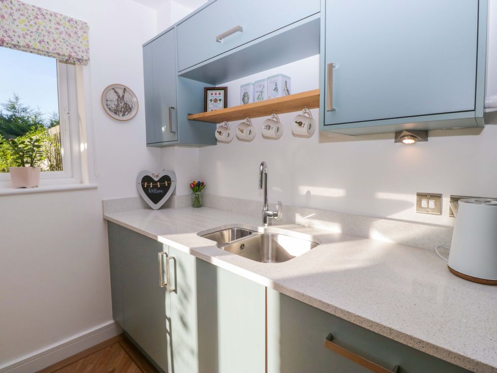 A kitchen with sink and cabinets at 27 Oversands View