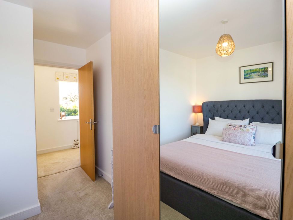 A bedroom with a bed and lamp at 27 Oversands View 