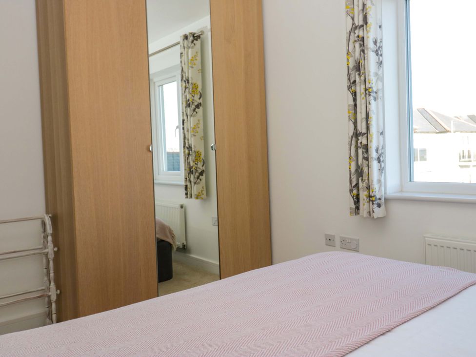 A bedroom with a bed and wardrobe at 27 Oversands View