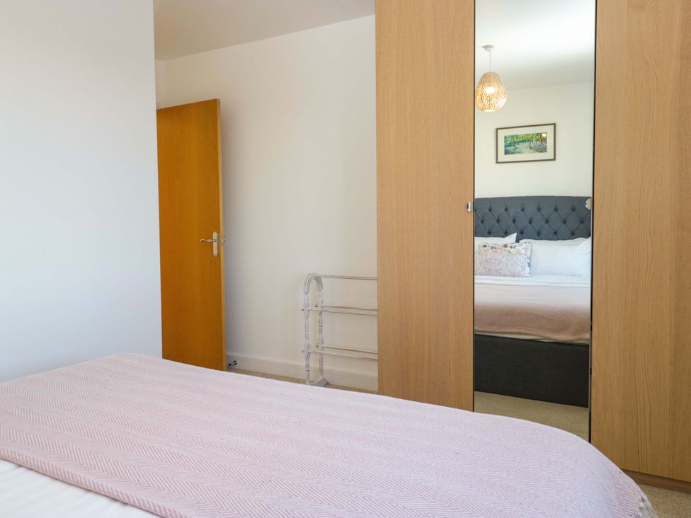 A bedroom with a bed and wardrobe at 27 Oversands View in 