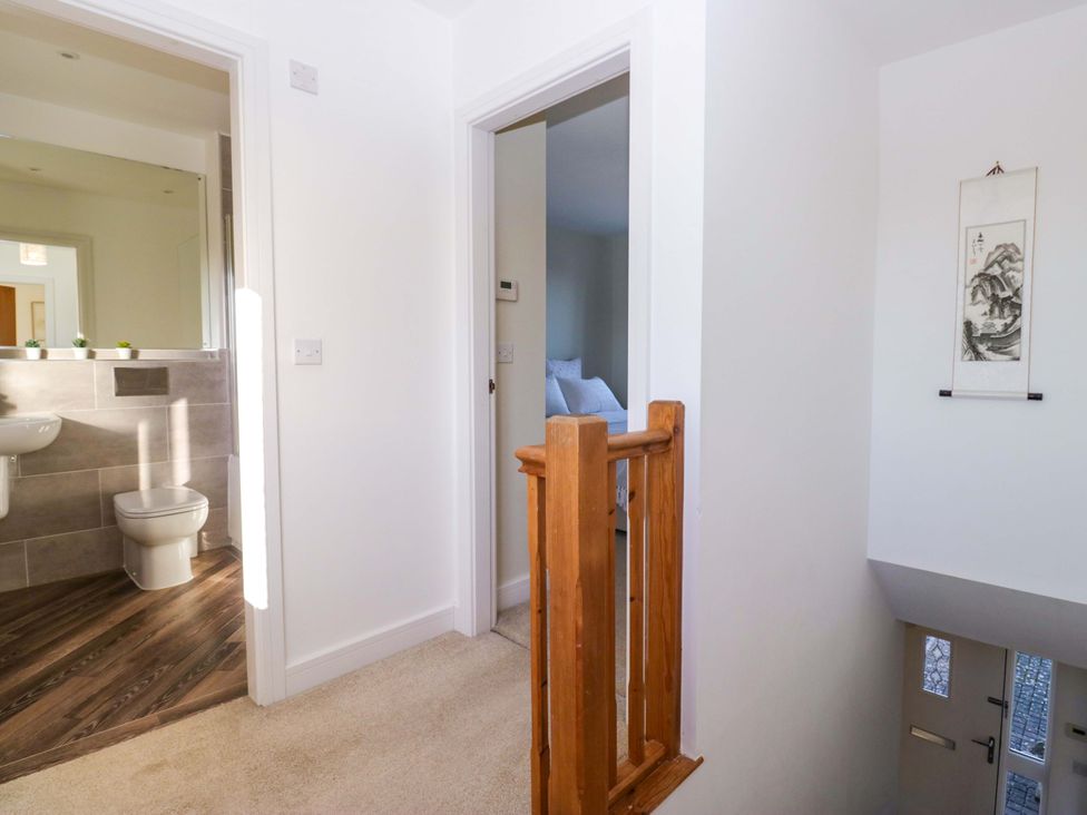 A hallway with a sink and toilet visible at 27 Oversands View