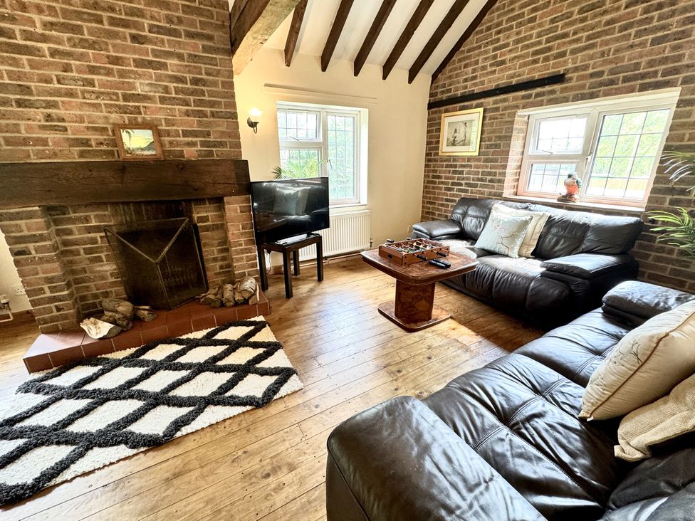 A living room with a fireplace and sofa at Forest Break in Southampton