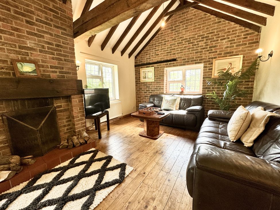A living room with a fireplace and sofa at Forest Break in Southampton