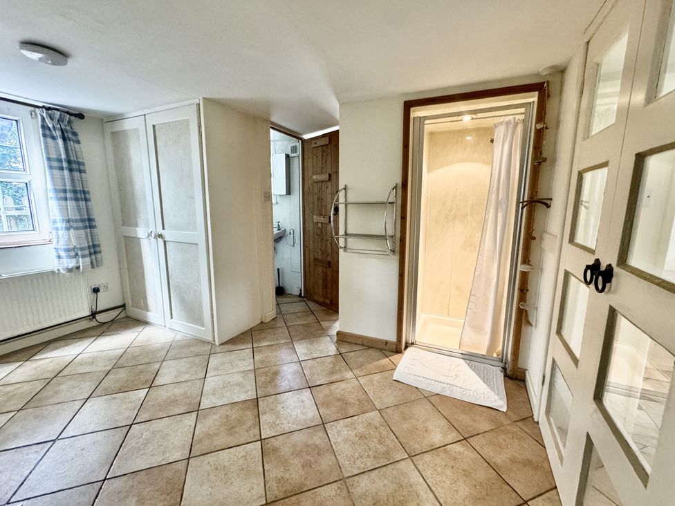A bathroom with a shower and cabinet at Forest Break in Southampton