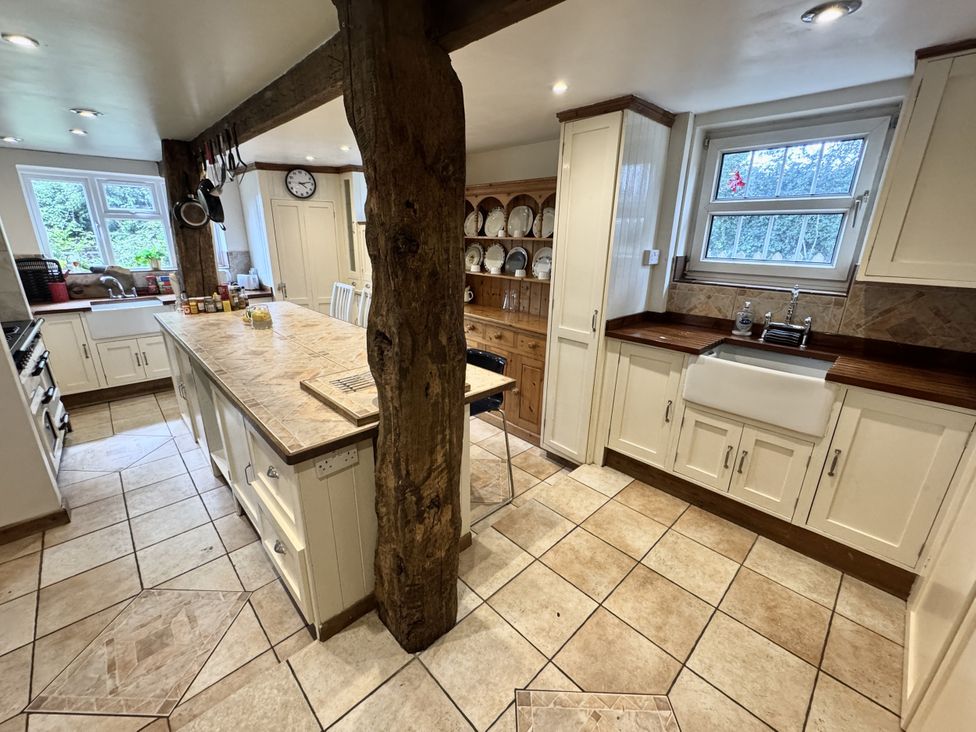 A kitchen with a central island and a sink at Forest Break in Southampton