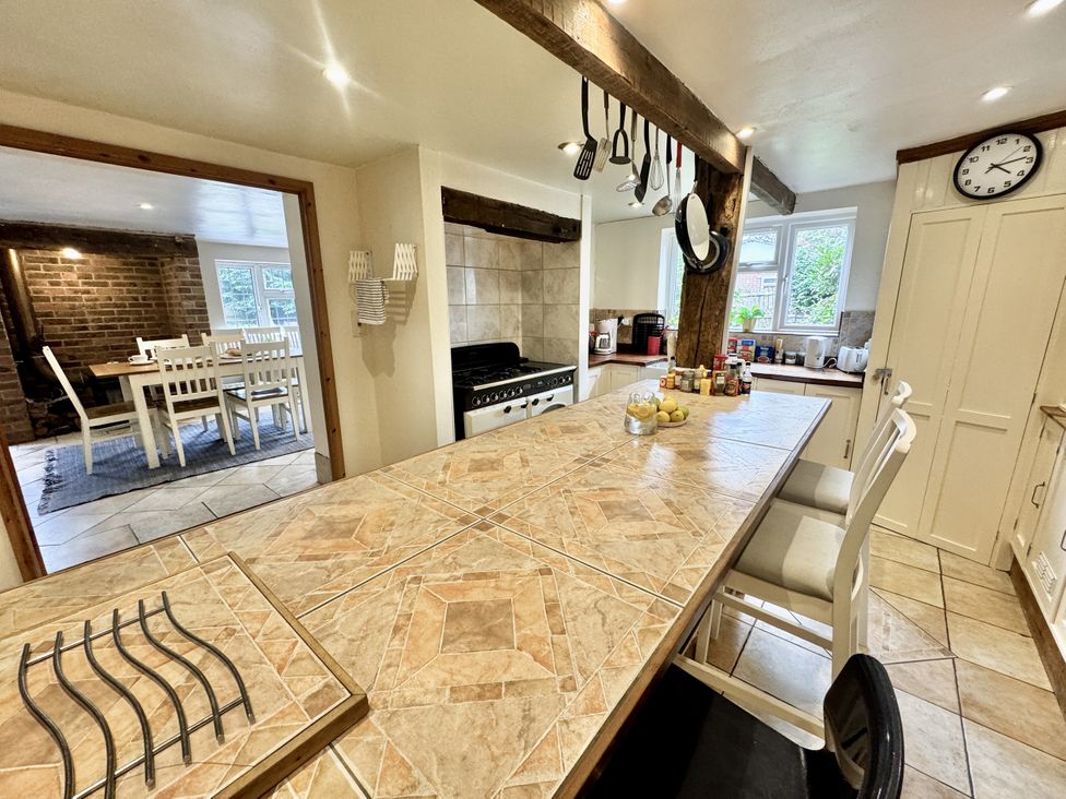 A kitchen with a gas stove and a dining area at Forest Break in Southampton