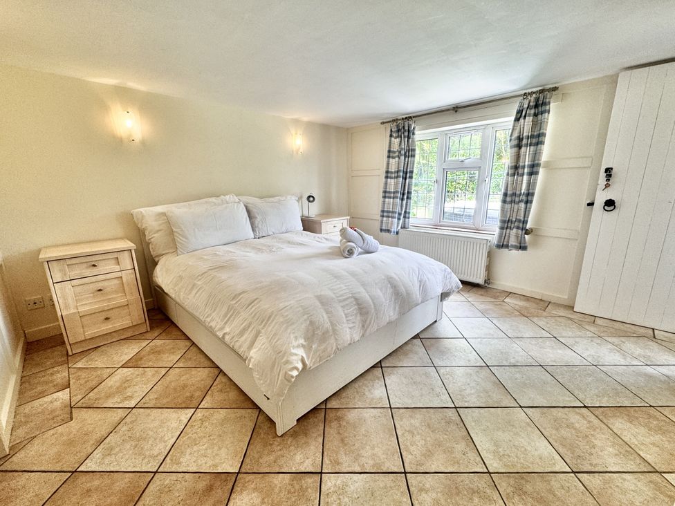 A bedroom with a bed and nightstand at Forest Break in Southampton