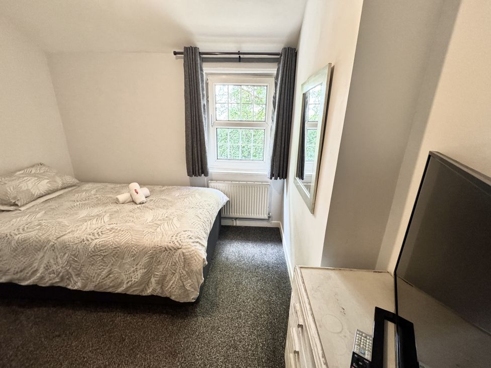 A bedroom with a bed and TV at Forest Break in Southampton