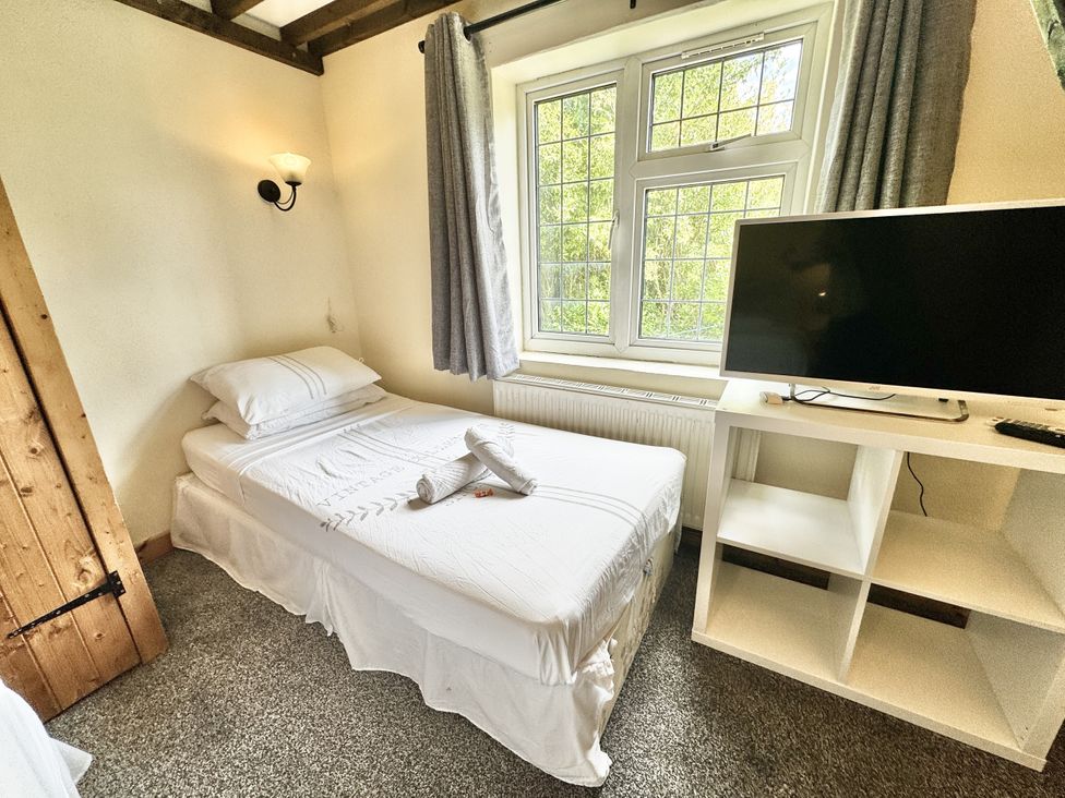 A bedroom with a bed and a television at Forest Break in Southampton