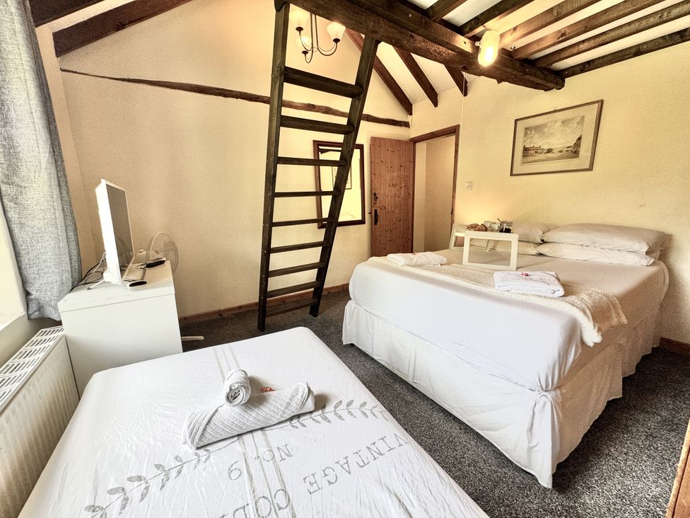 A bedroom with two beds and a ladder at Forest Break Southampton