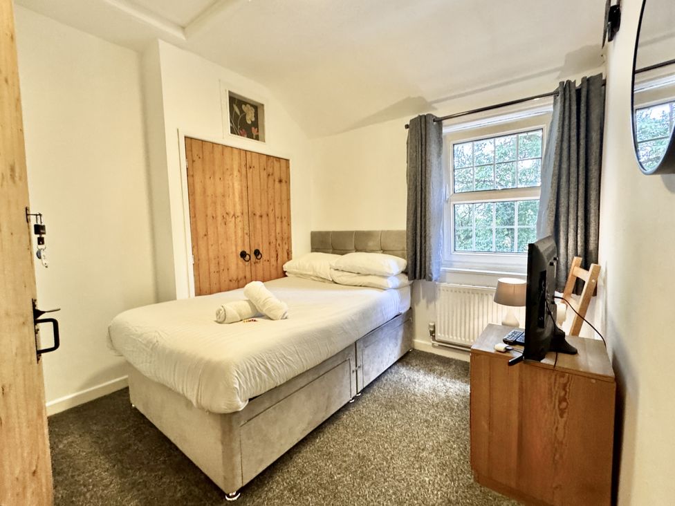 A bedroom with a bed and television at Forest Break in Southampton