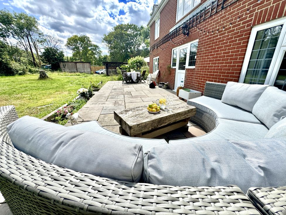 An outdoor seating area with a sofa and coffee table at Forest Break in Southampton
