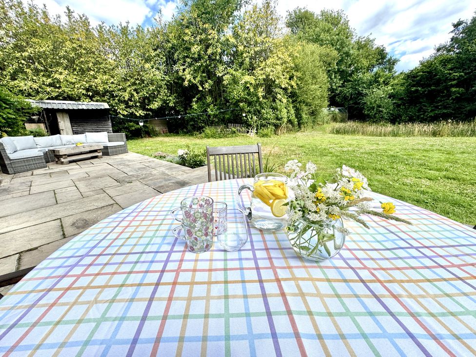 An outdoor area with a table, glasses, and a water pitcher at Forest Break in Southampton