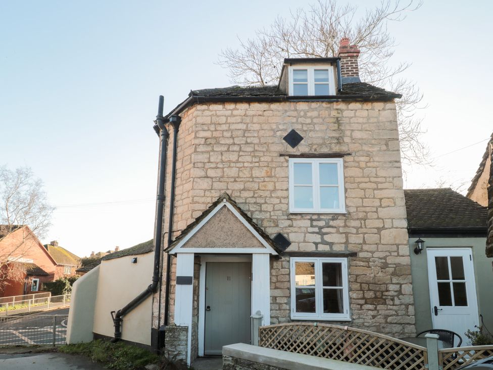 A house with stone walls and multiple windows at The Corner Cottage in Gloucester