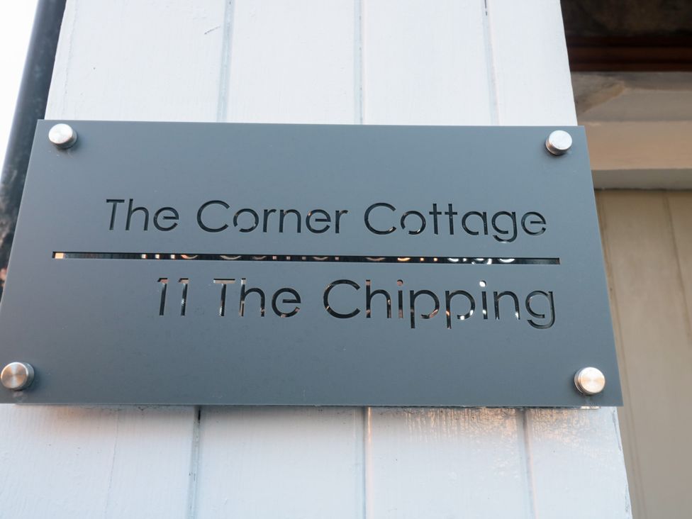 A sign displaying The Corner Cottage 11 The Chipping Gloucester