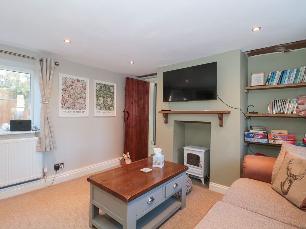 A living room with a coffee table and sofa at The Corner Cottage in Gloucester