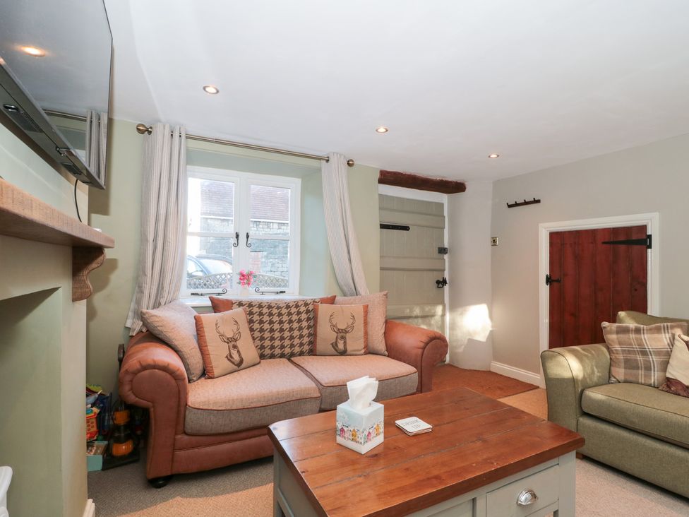 A living room with a sofa and coffee table at The Corner Cottage in Gloucester
