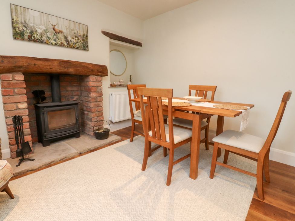 A dining room with a table and chairs at Cobble Cottage in Clitheroe