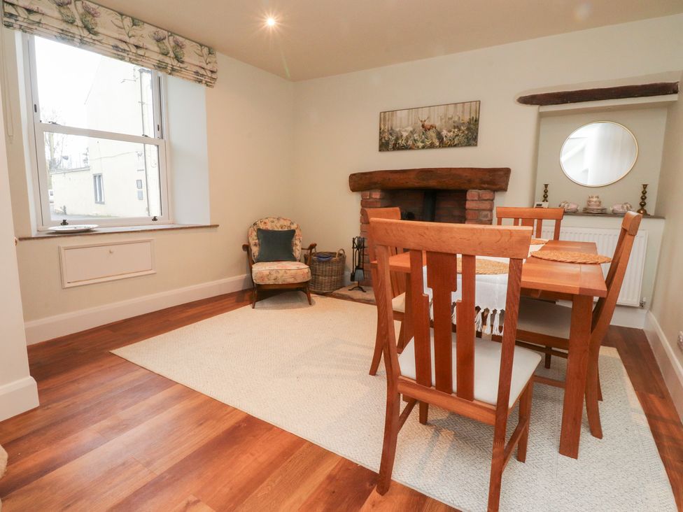 A dining room with a table and chairs at Cobble Cottage in Clitheroe