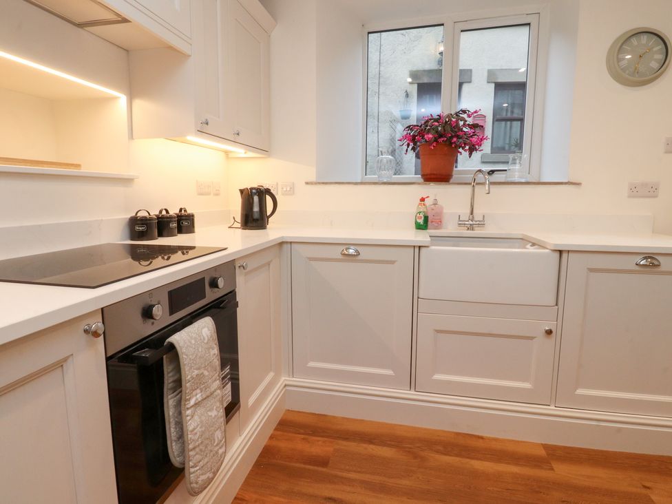 A kitchen with a sink and stove at Cobble Cottage in Clitheroe