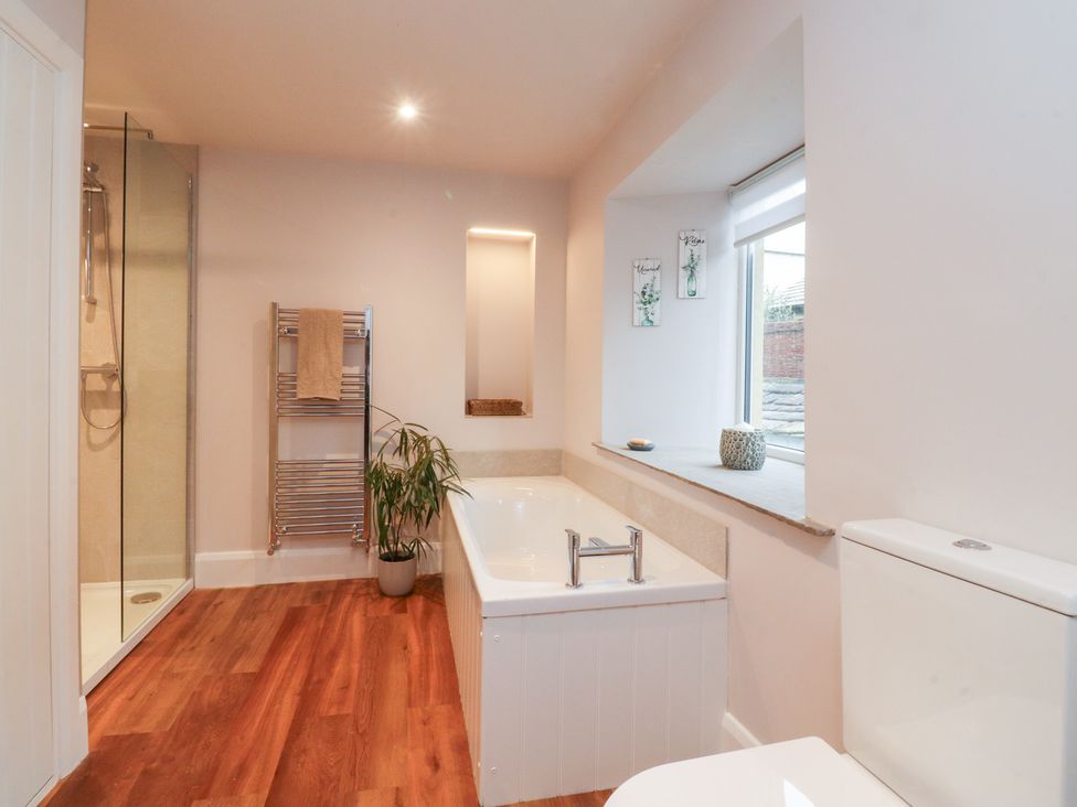 A bathroom with a bathtub and shower at Cobble Cottage in Clitheroe