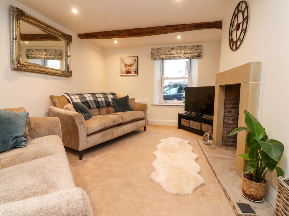 A living room with a sofa and television at Cobble Cottage in Gisburn