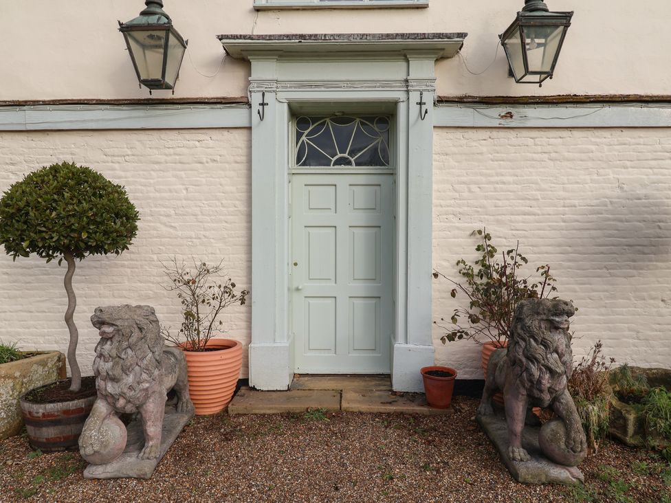 An entrance with lion statues and plants at the Farmhouse in Beccles