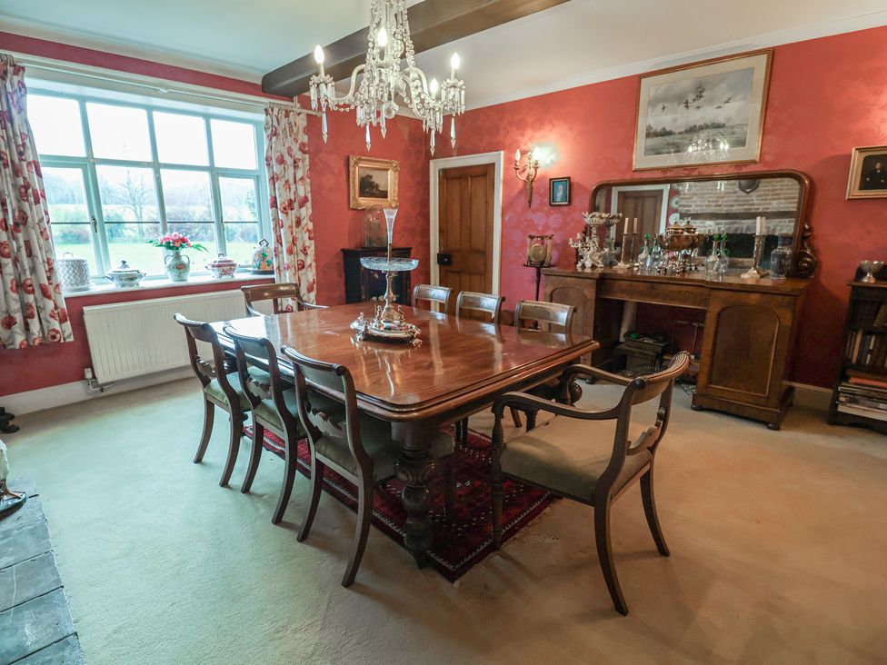 A dining room with a table and chairs at Farmhouse in Beccles
