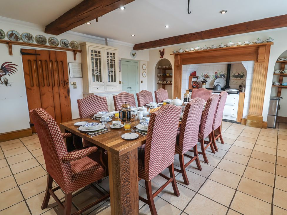 A dining room with a large table set for breakfast at Farmhouse in Beccles