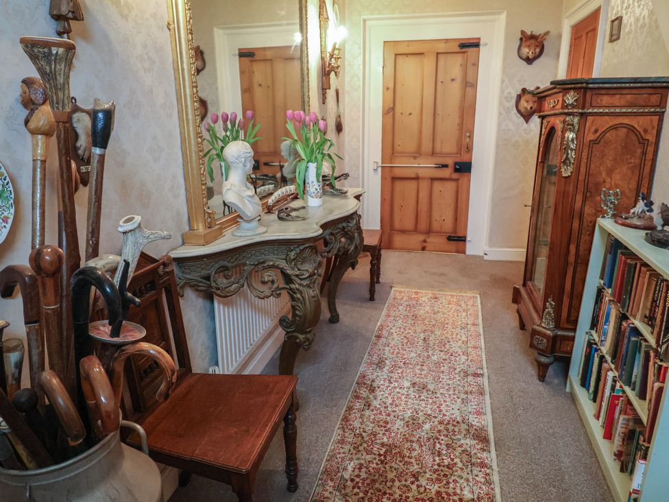 A hallway with decorative items and furniture at Farmhouse in Beccles