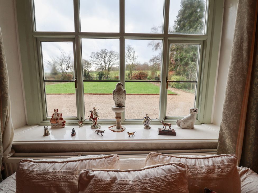 A window with decorative figurines on the sill at the Farmhouse in Beccles