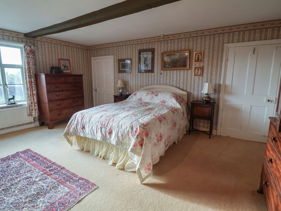 A bedroom with a bed and furniture at Farmhouse in Beccles