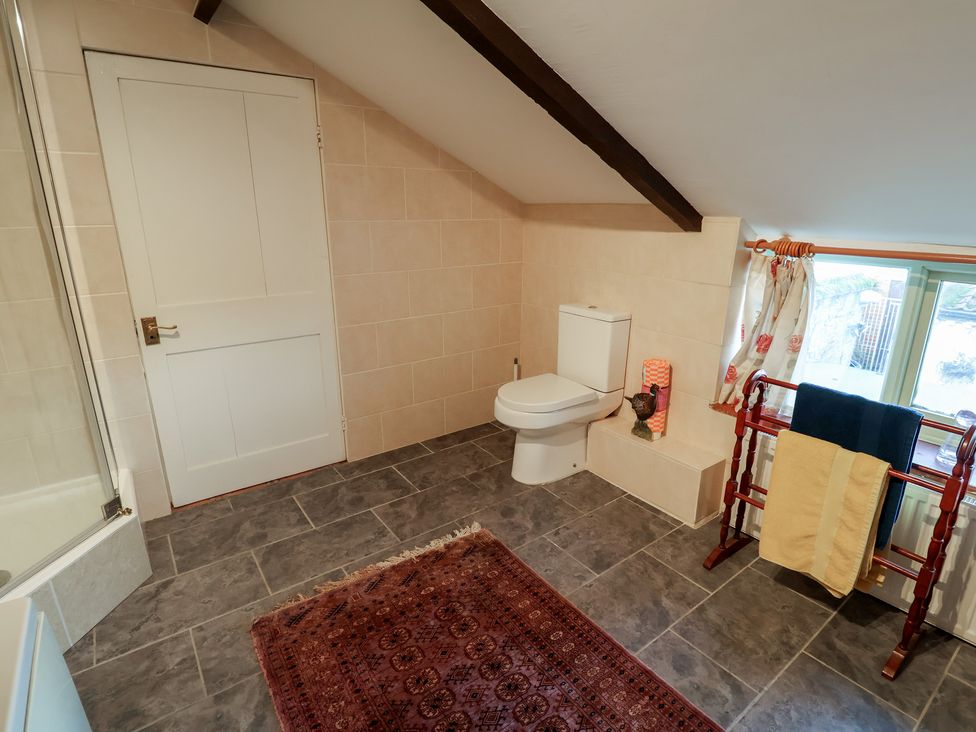 A bathroom with a toilet and a towel rail at Farmhouse in Beccles